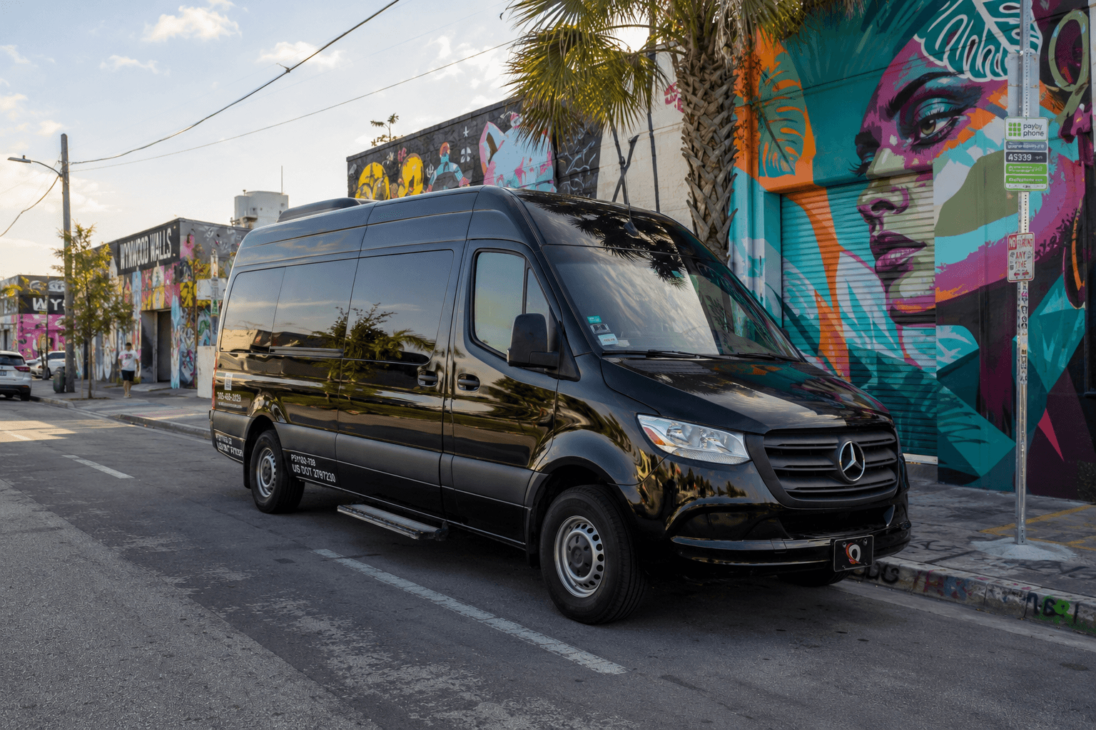 Miami Bus Company Sprinter van parked in front of the Wynwood Walls street art in Miami
