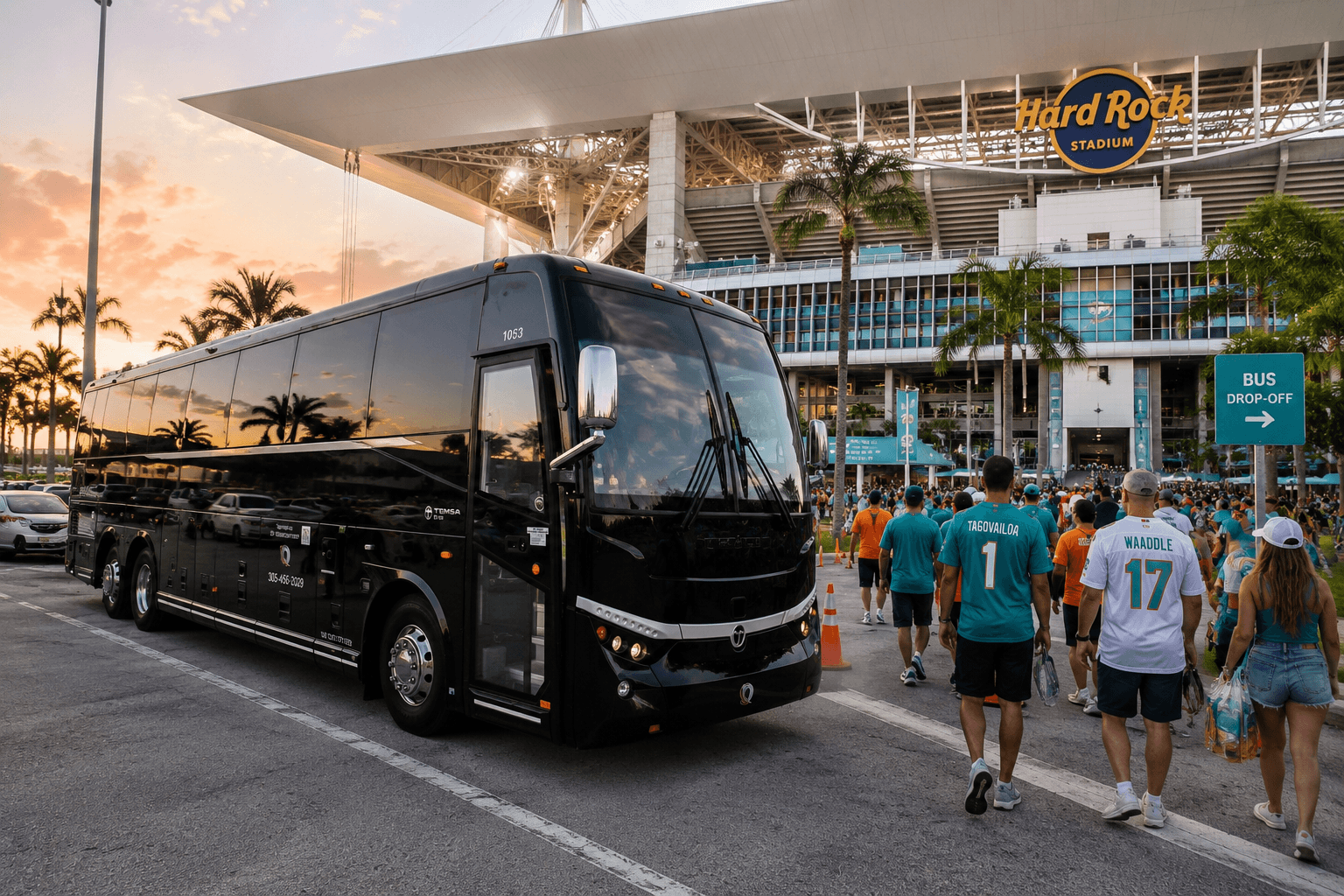 An Miami Bus Company motorcoach parked outside Hard Rock Stadium with fans walking in for a game
