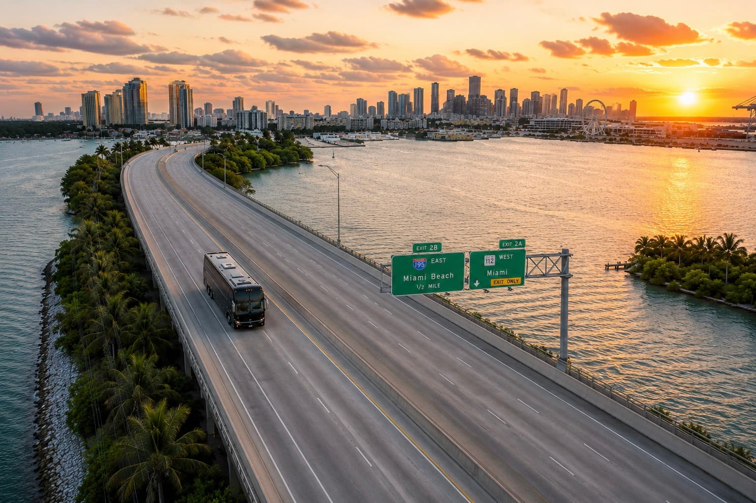 Miami Bus Company full-size motorcoach crossing the I-195 causeway in Miami at sunset, downtown skyline behind it